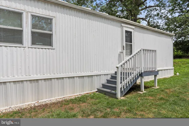 a view of a house with backyard and deck