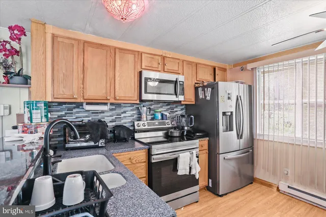a kitchen with a refrigerator stove and sink