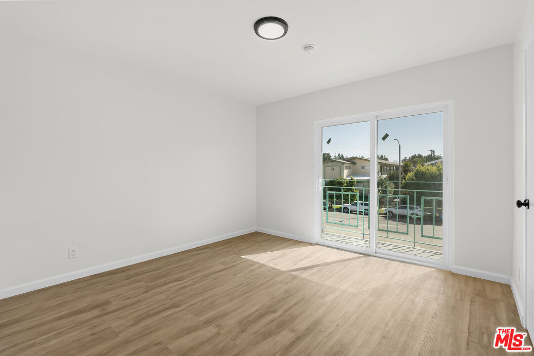 7825 West Manchester Avenue, Unit 23 Playa del Rey, CA 90293 - Photo 9 of 14 wooden floor in an empty room with a window