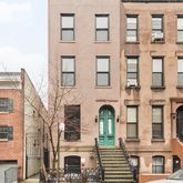 a front view of a residential apartment building with a yard