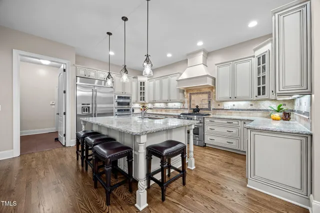 a view of a dining room with furniture a chandelier and wooden floor