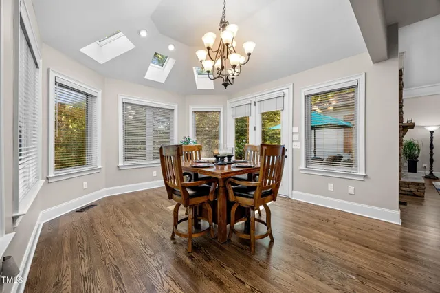 a spacious bathroom with a double vanity sink mirror and a bathtub