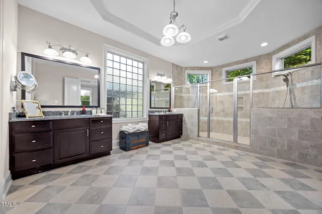 a bathroom with a sink double vanity granite and a mirror