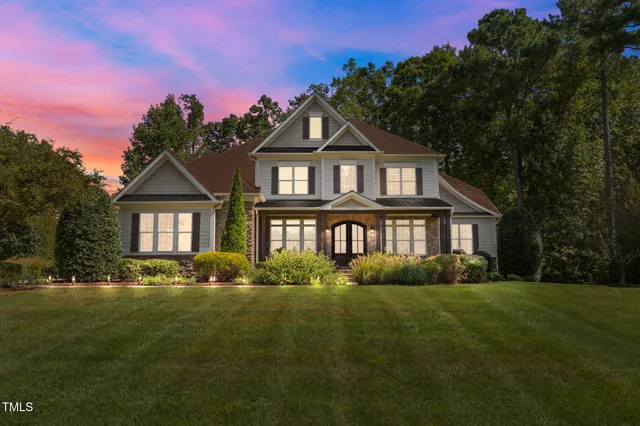 a front view of a house with a yard table and chairs