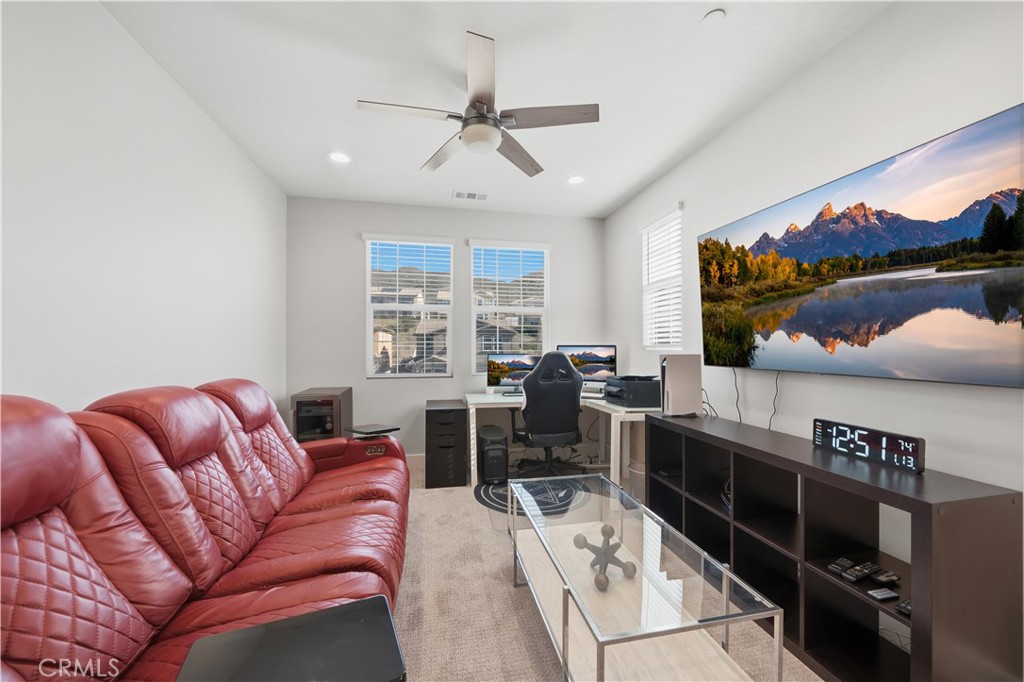 346 Ventasso Way Fallbrook, CA 92028 - Photo 36 of 56 a living room with furniture a flat screen tv and a floor to ceiling window
