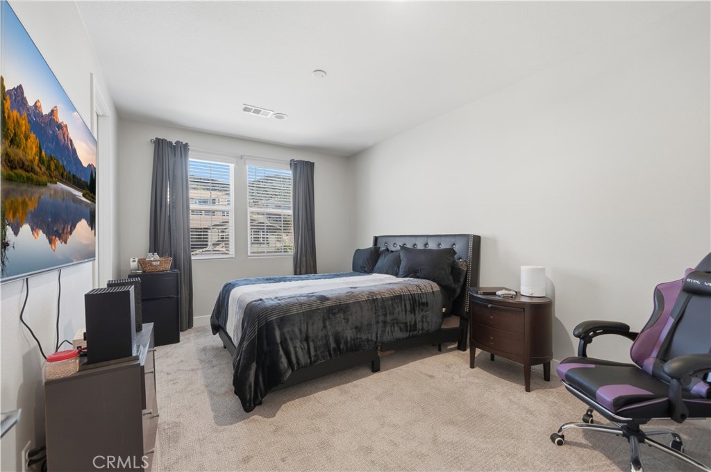 346 Ventasso Way Fallbrook, CA 92028 - Photo 38 of 56 a spacious bedroom with a bed a desk and chair with window