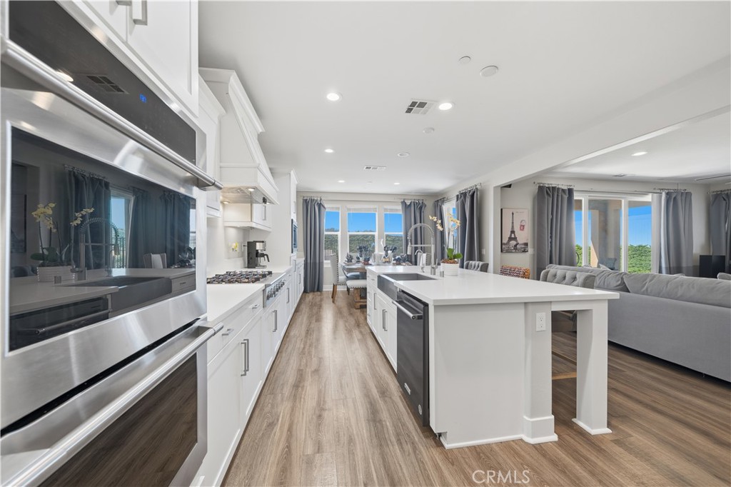 346 Ventasso Way Fallbrook, CA 92028 - Photo 10 of 56 a large kitchen with stainless steel appliances kitchen island a large counter top and a stove