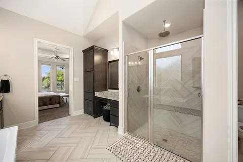 a bathroom with a shower and a sink