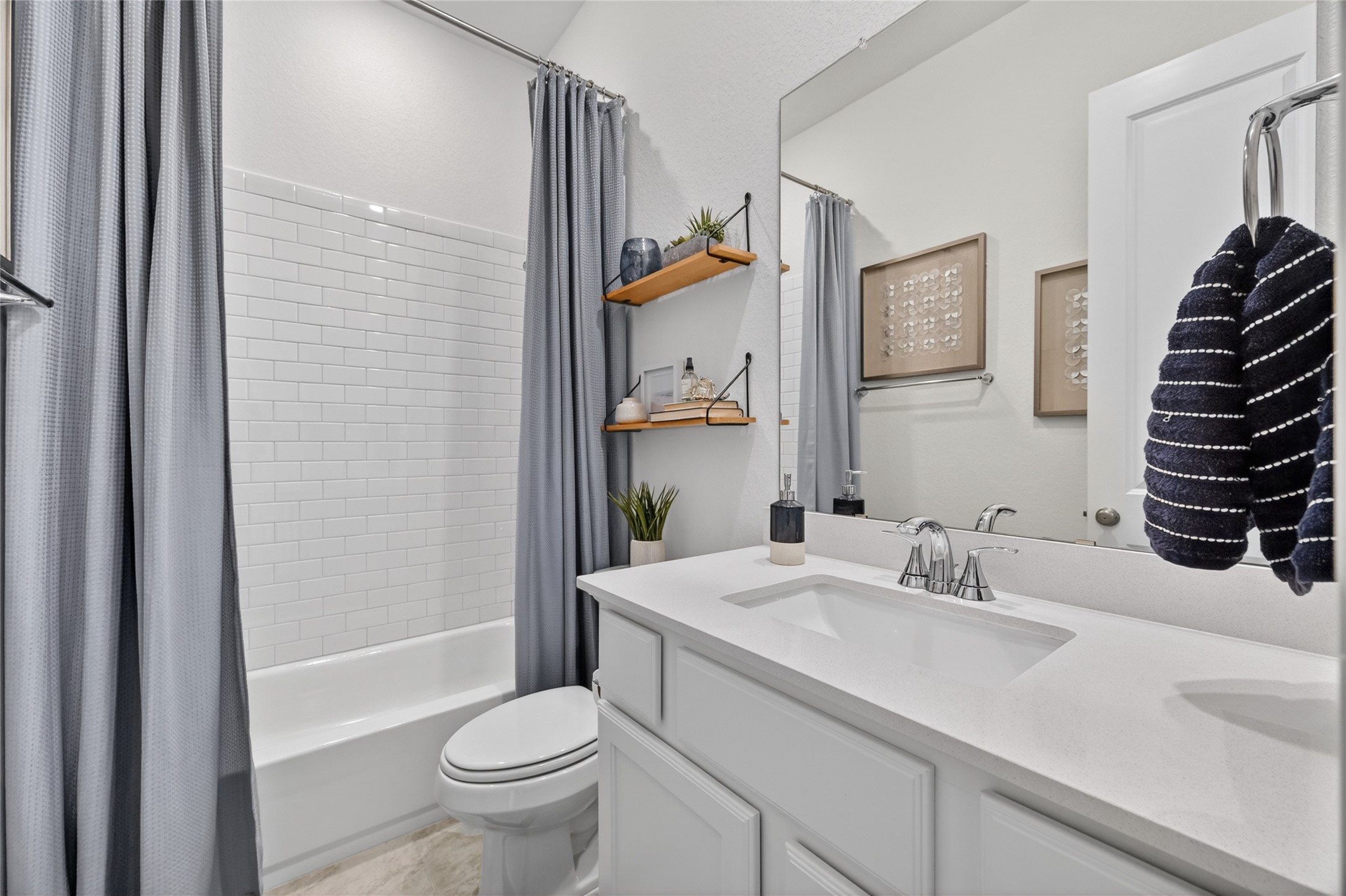 4439 Stone Ridge Lane Manvel, TX 77578 - Photo 31 of 48 a bathroom with a sink a toilet and shower curtain
