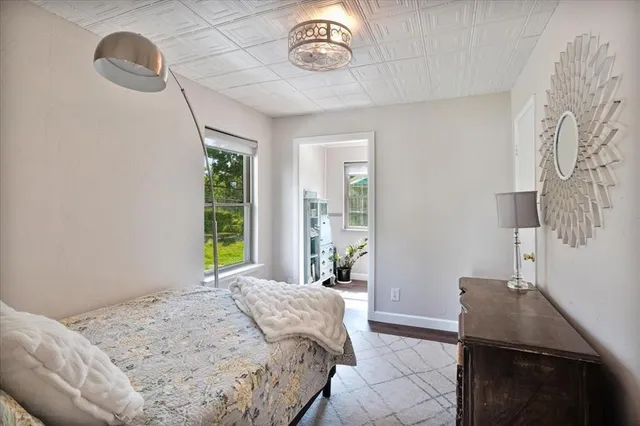 a bedroom with a bed and window