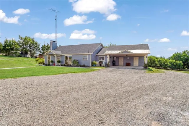 a view of house with a yard