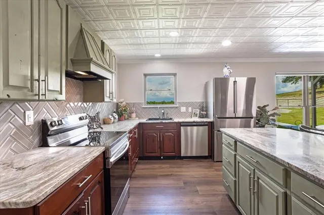a kitchen with a sink stove and refrigerator