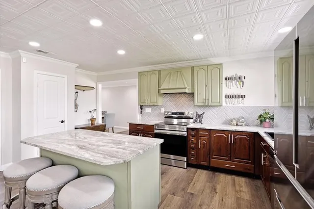 a kitchen with stainless steel appliances granite countertop a sink stove and refrigerator