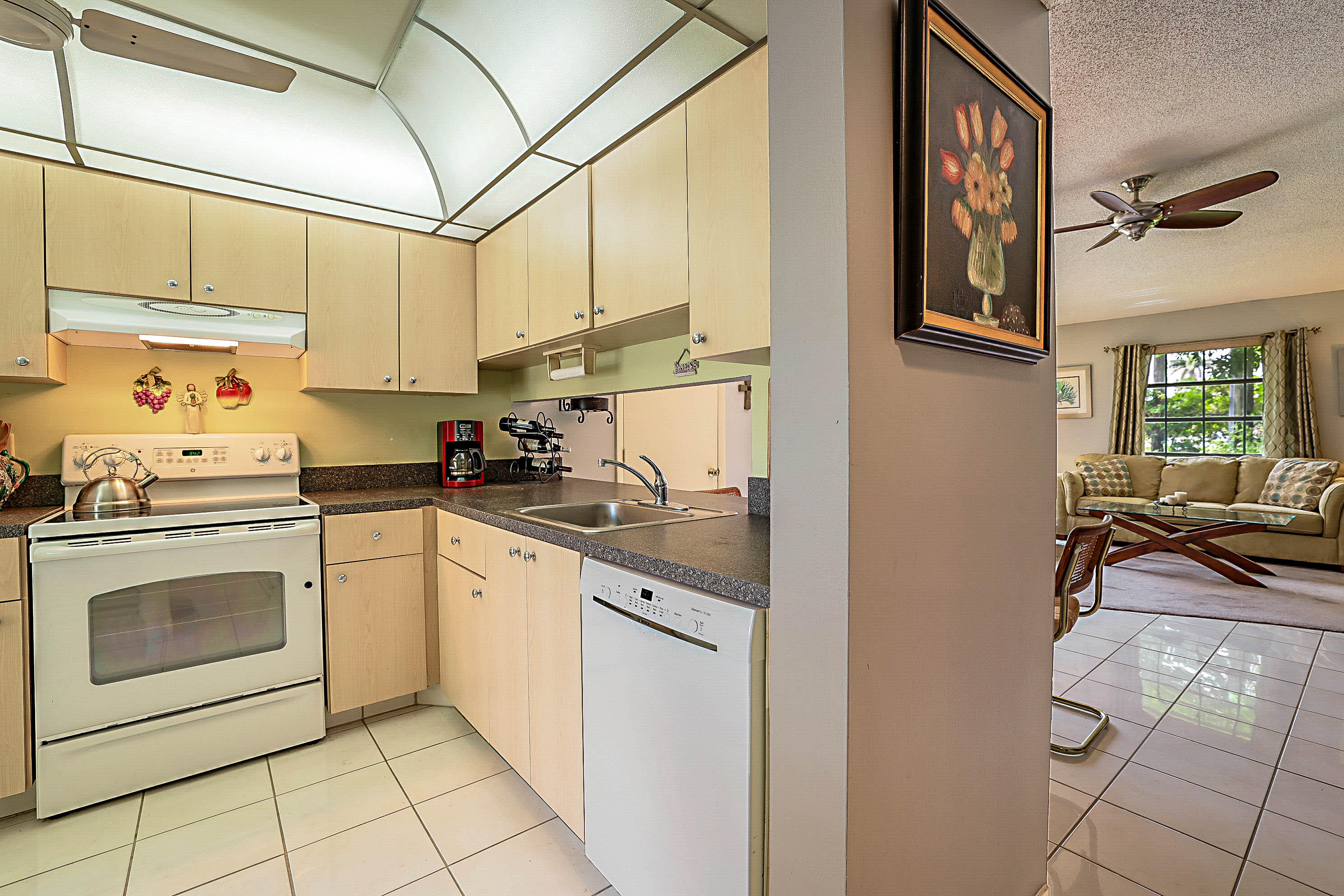 5231 Copperleaf Circle Delray Beach, FL 33484 - Photo 11 of 31 a kitchen with stainless steel appliances granite countertop a sink a stove and cabinets
