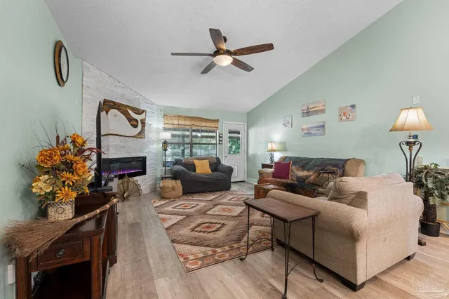 a living room with furniture and a potted plant