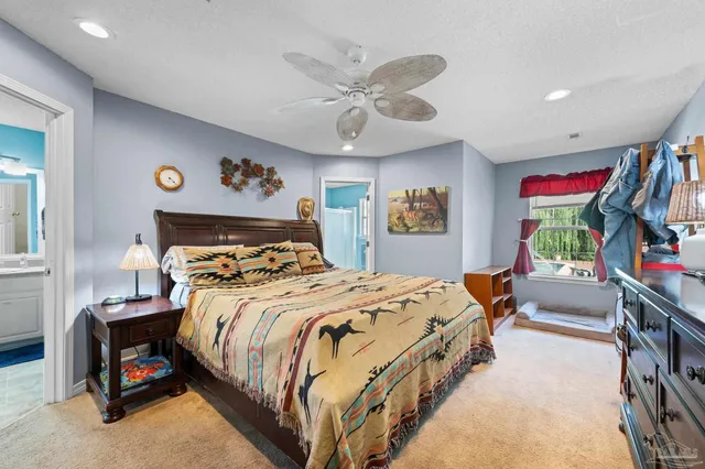 a bedroom with bed and a chandelier