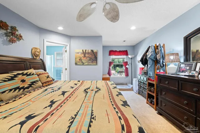 a bed room with a bed mirror and a window