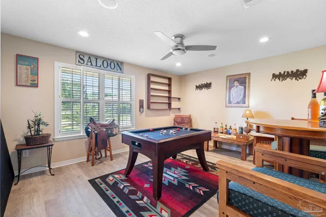 a living room with furniture a large window and a table