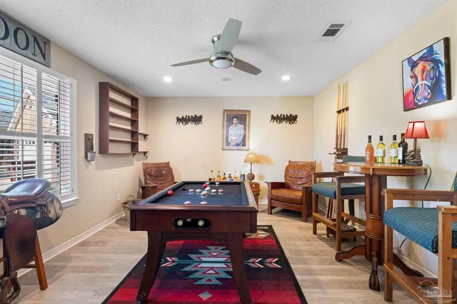 a living room with furniture a rug and a flat screen tv
