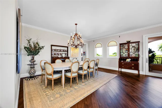 a kitchen with a wooden floors a stove and white stainless steel appliances