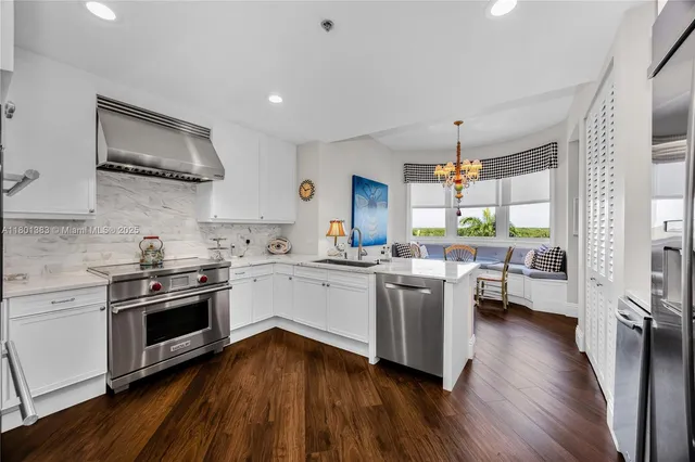 a kitchen with sink refrigerator and cabinets