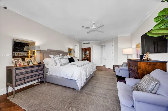 a large kitchen with kitchen island white cabinets and stainless steel appliances