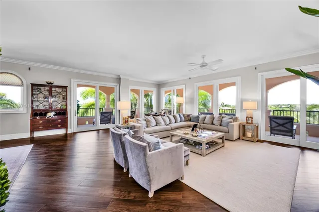 a living room with furniture fireplace and a large window