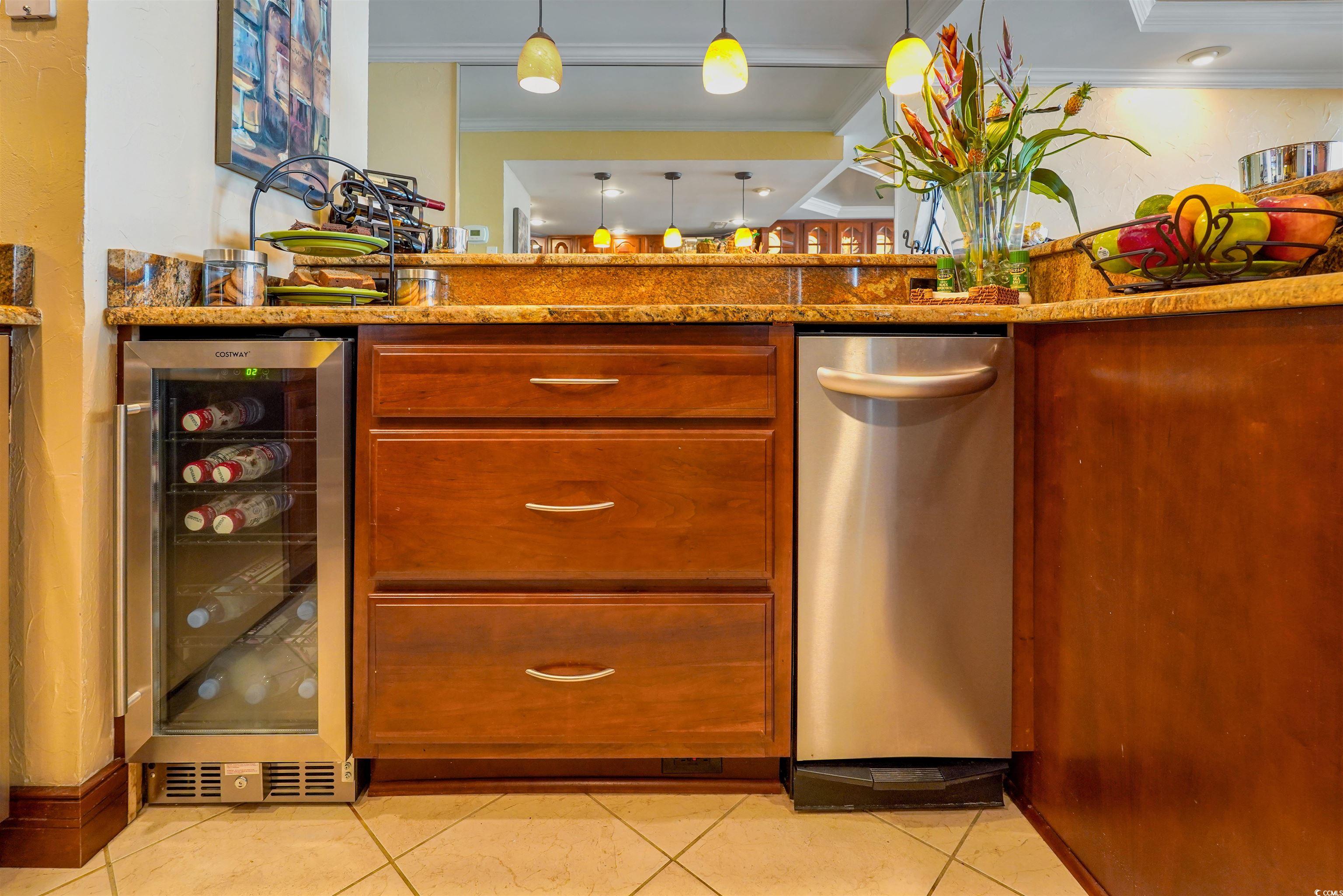 1012 North Waccamaw Drive, Unit 305 Murrells Inlet, SC 29576 - Photo 17 of 38 Kitchen featuring beverage cooler, stainless steel dishwasher, crown molding, light tile patterned floors, and light stone countertops