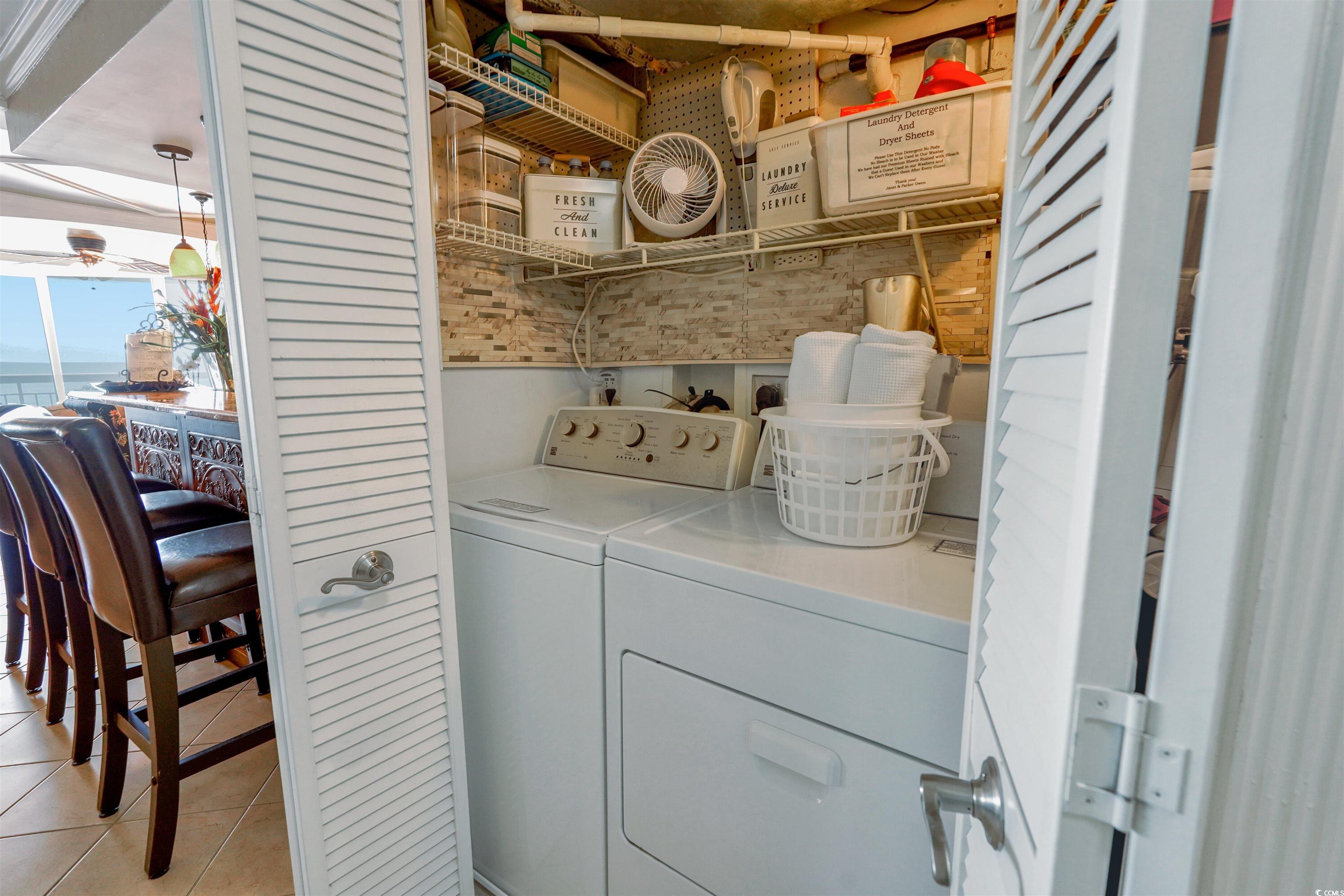 1012 North Waccamaw Drive, Unit 305 Murrells Inlet, SC 29576 - Photo 21 of 38 Clothes washing area with washer and clothes dryer and light tile patterned floors