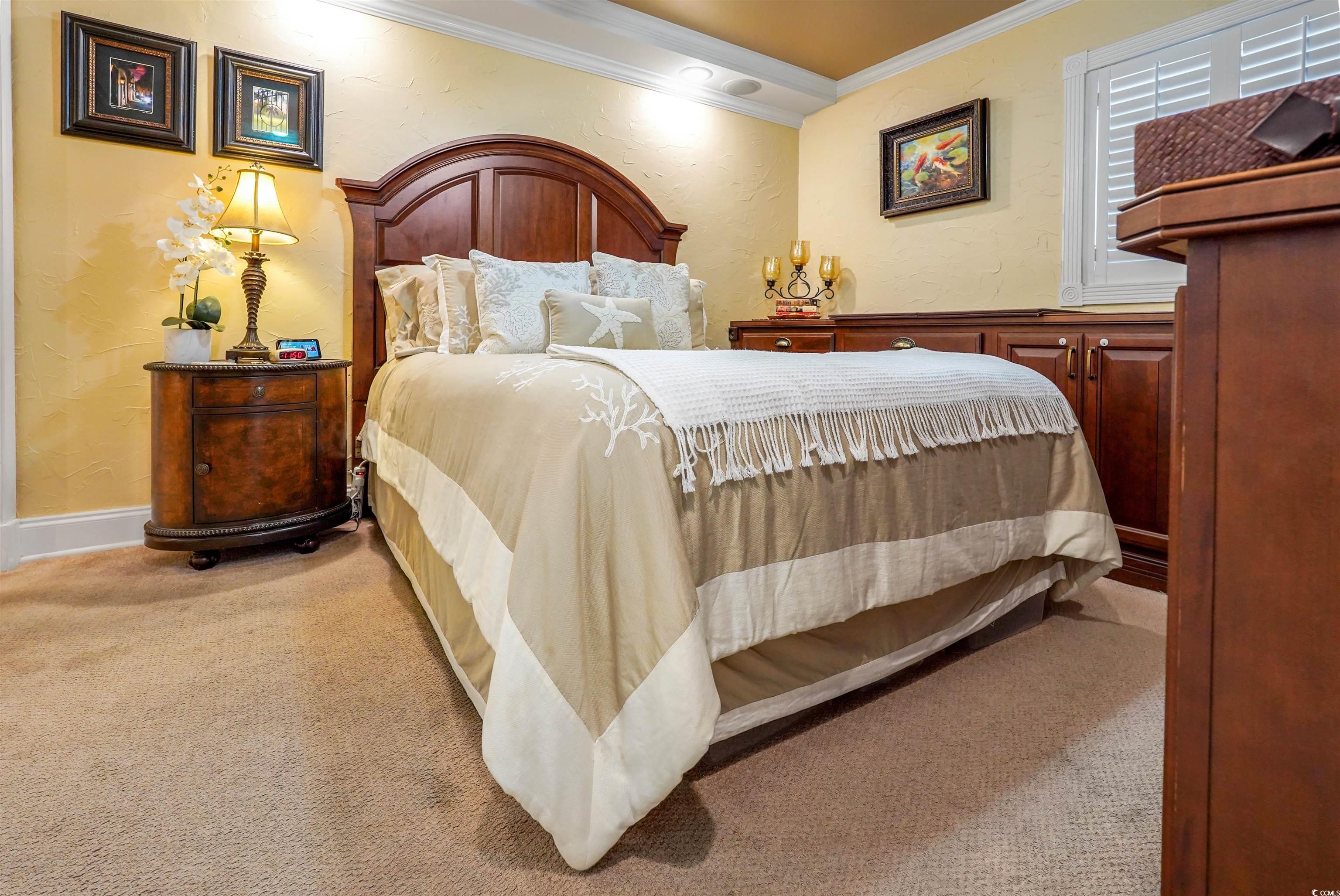 1012 North Waccamaw Drive, Unit 305 Murrells Inlet, SC 29576 - Photo 23 of 38 Bedroom featuring ornamental molding and carpet floors