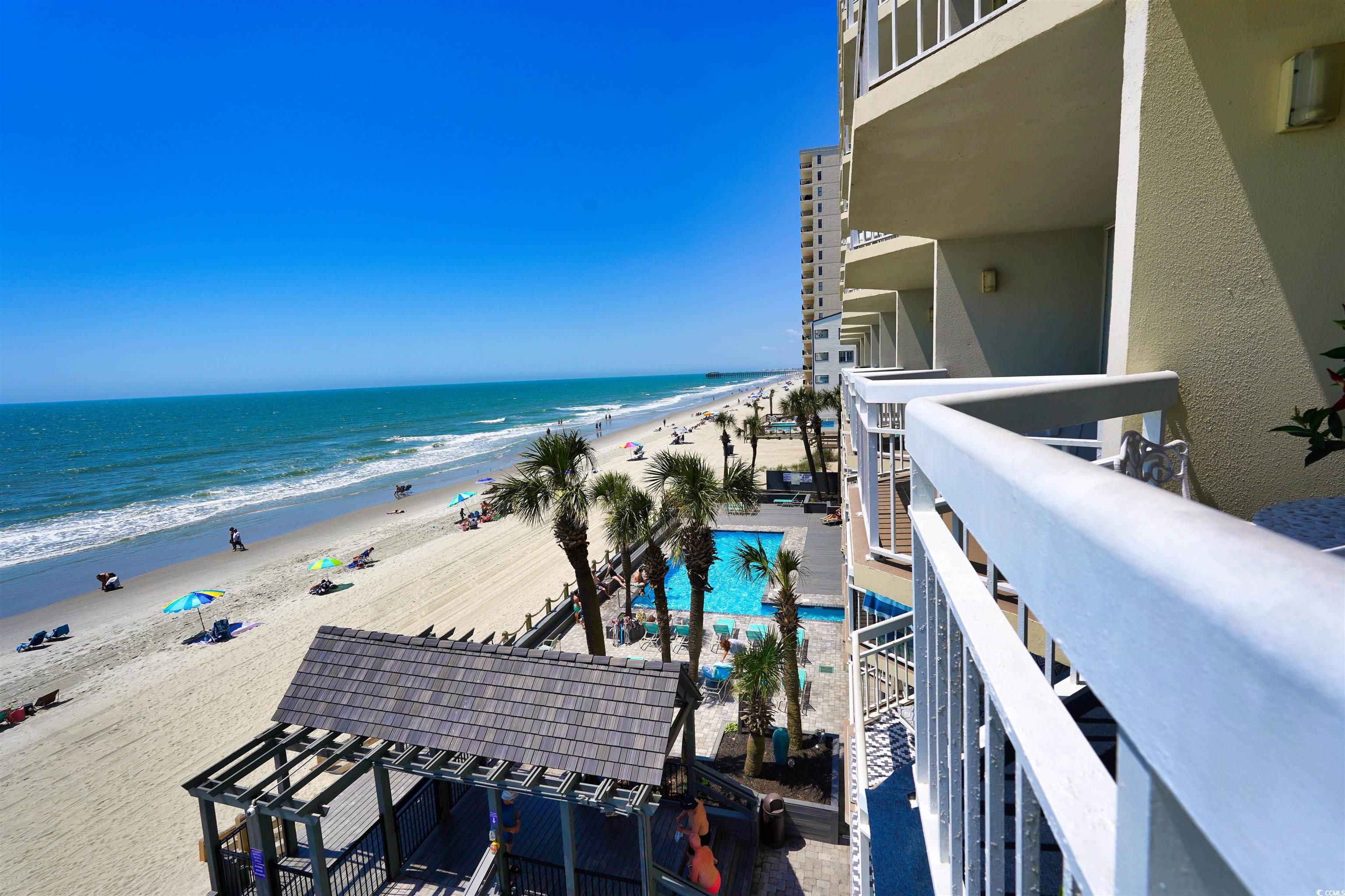 1012 North Waccamaw Drive, Unit 305 Murrells Inlet, SC 29576 - Photo 31 of 38 Balcony with view of water and beach and view of pool area