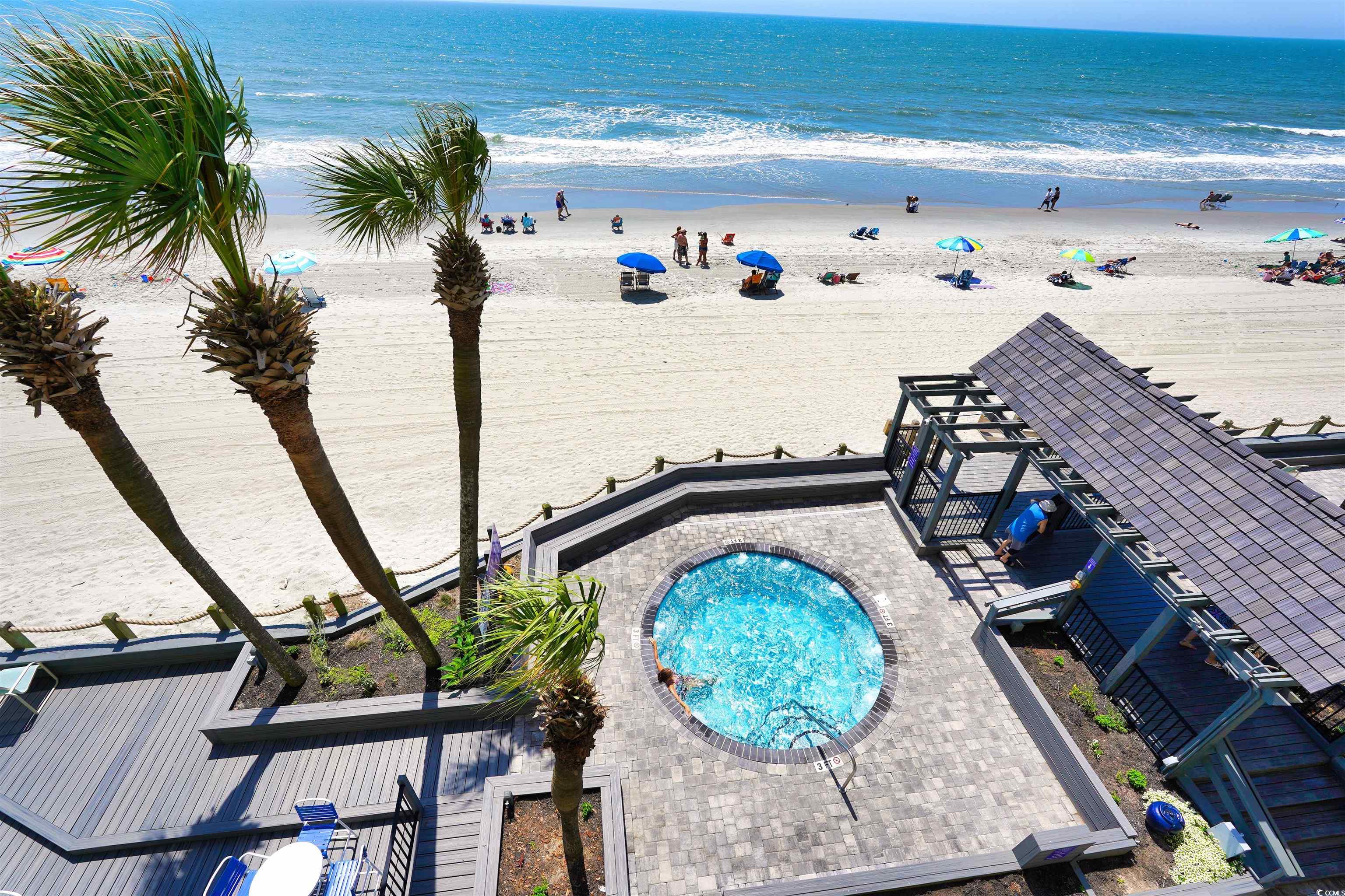 1012 North Waccamaw Drive, Unit 305 Murrells Inlet, SC 29576 - Photo 36 of 38 View of pool featuring view of water and beach