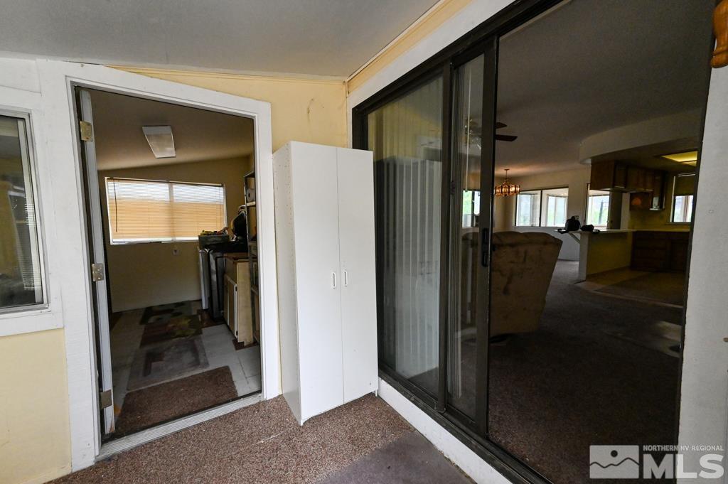 559 Mule Deer Road Coleville, CA 96107 - Photo 17 of 40 a hallway with a dining table and a glass door