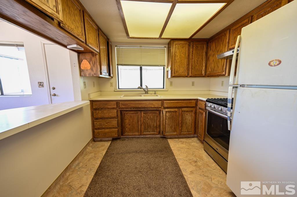 559 Mule Deer Road Coleville, CA 96107 - Photo 23 of 40 a kitchen with stainless steel appliances a sink and cabinets