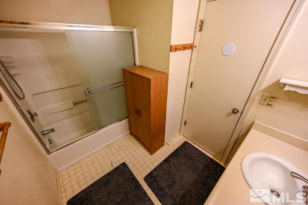 559 Mule Deer Road Coleville, CA 96107 - Photo 26 of 40 a bathroom with a sink a toilet a mirror and shower