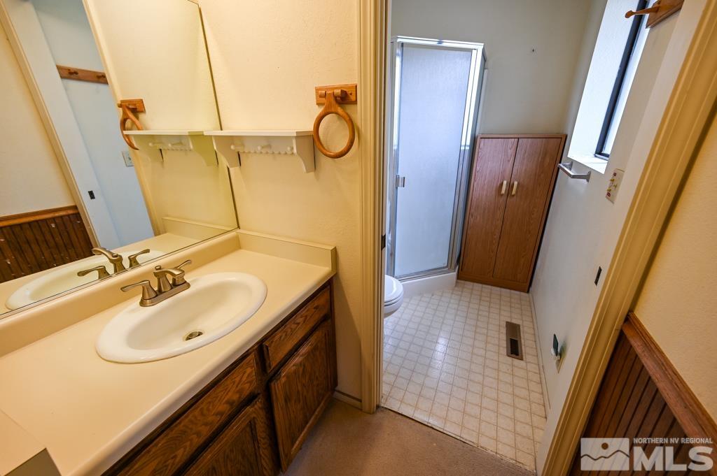 559 Mule Deer Road Coleville, CA 96107 - Photo 32 of 40 a bathroom with a sink a mirror and a shower