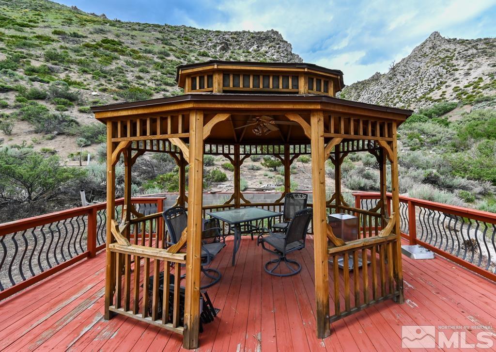 559 Mule Deer Road Coleville, CA 96107 - Photo 35 of 40 a view of a roof deck with table and chairs with wooden deck
