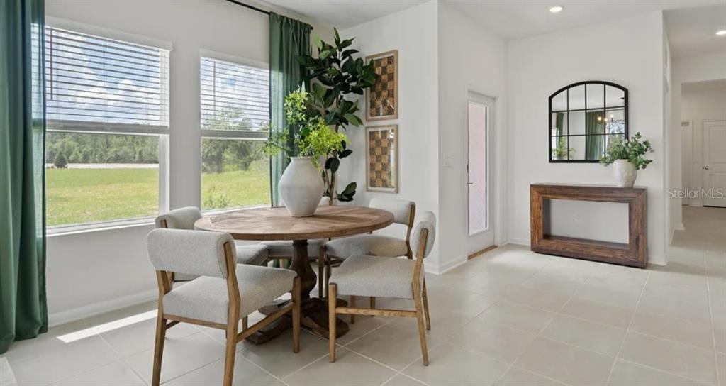 4246 St Thomas Way Kissimmee, FL 34758 - Photo 6 of 16 a view of a dining room with furniture and window