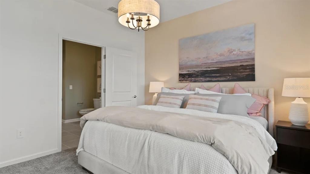 4246 St Thomas Way Kissimmee, FL 34758 - Photo 9 of 16 a bedroom with a bed and a painting on the wall