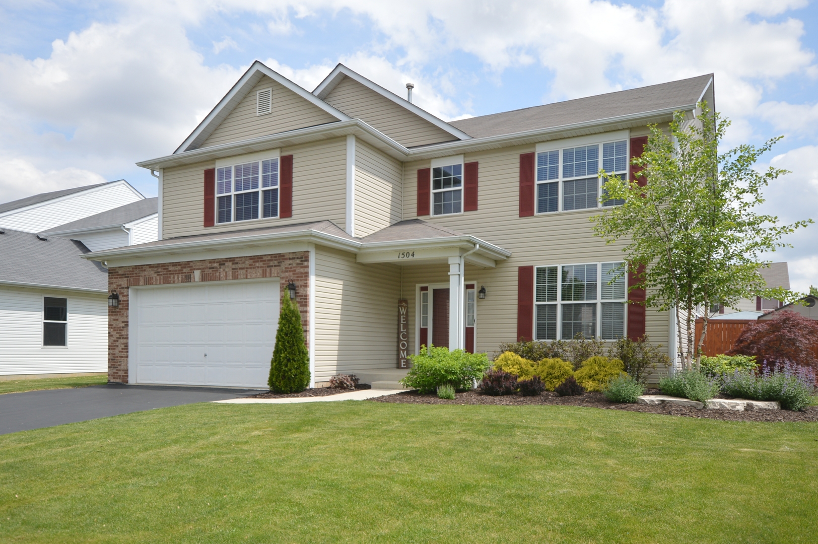 1504 Roth Drive Joliet, IL 60431 - Photo 1 of 27 a front view of a house with a yard and garage