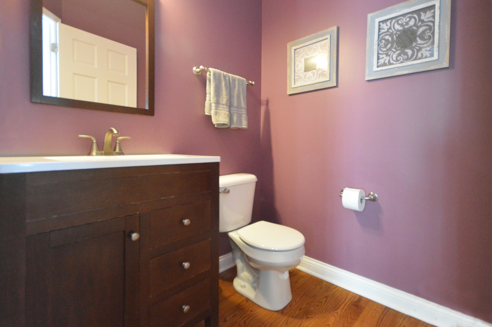 1504 Roth Drive Joliet, IL 60431 - Photo 14 of 27 a bathroom with a toilet sink vanity and mirror