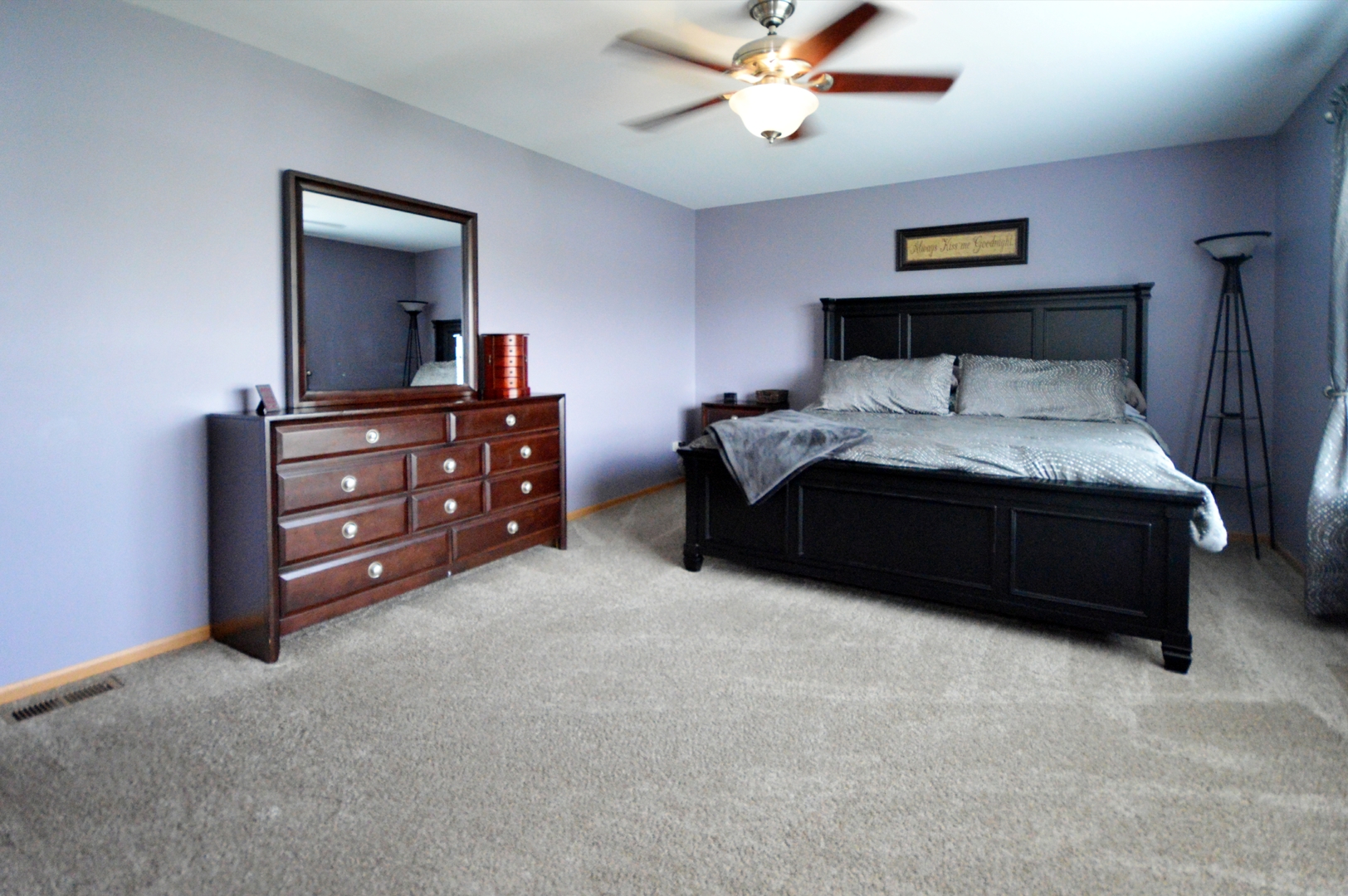 1504 Roth Drive Joliet, IL 60431 - Photo 16 of 27 a bedroom with a bed and a dresser