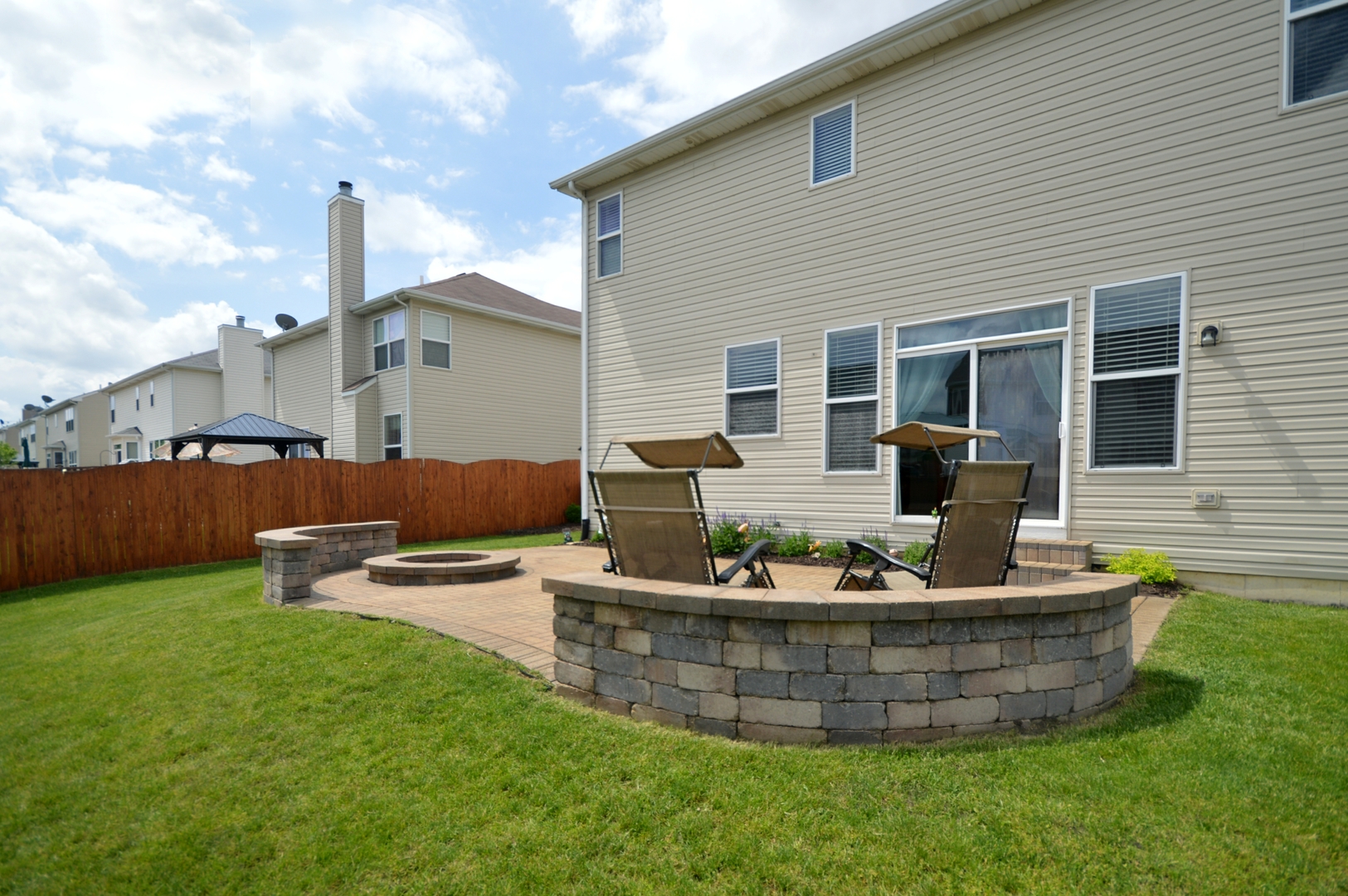 1504 Roth Drive Joliet, IL 60431 - Photo 25 of 27 a view of a house with backyard sitting area and furniture
