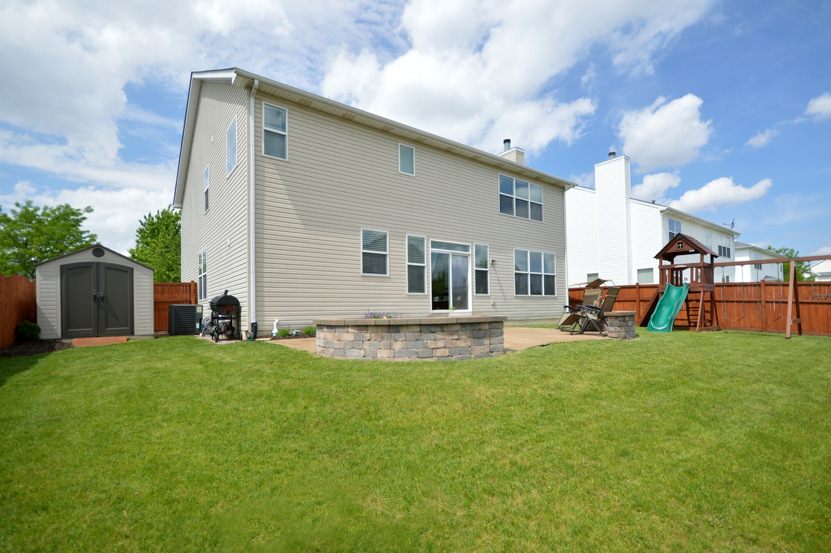 1504 Roth Drive Joliet, IL 60431 - Photo 27 of 27 a view of a house with a backyard and a tree