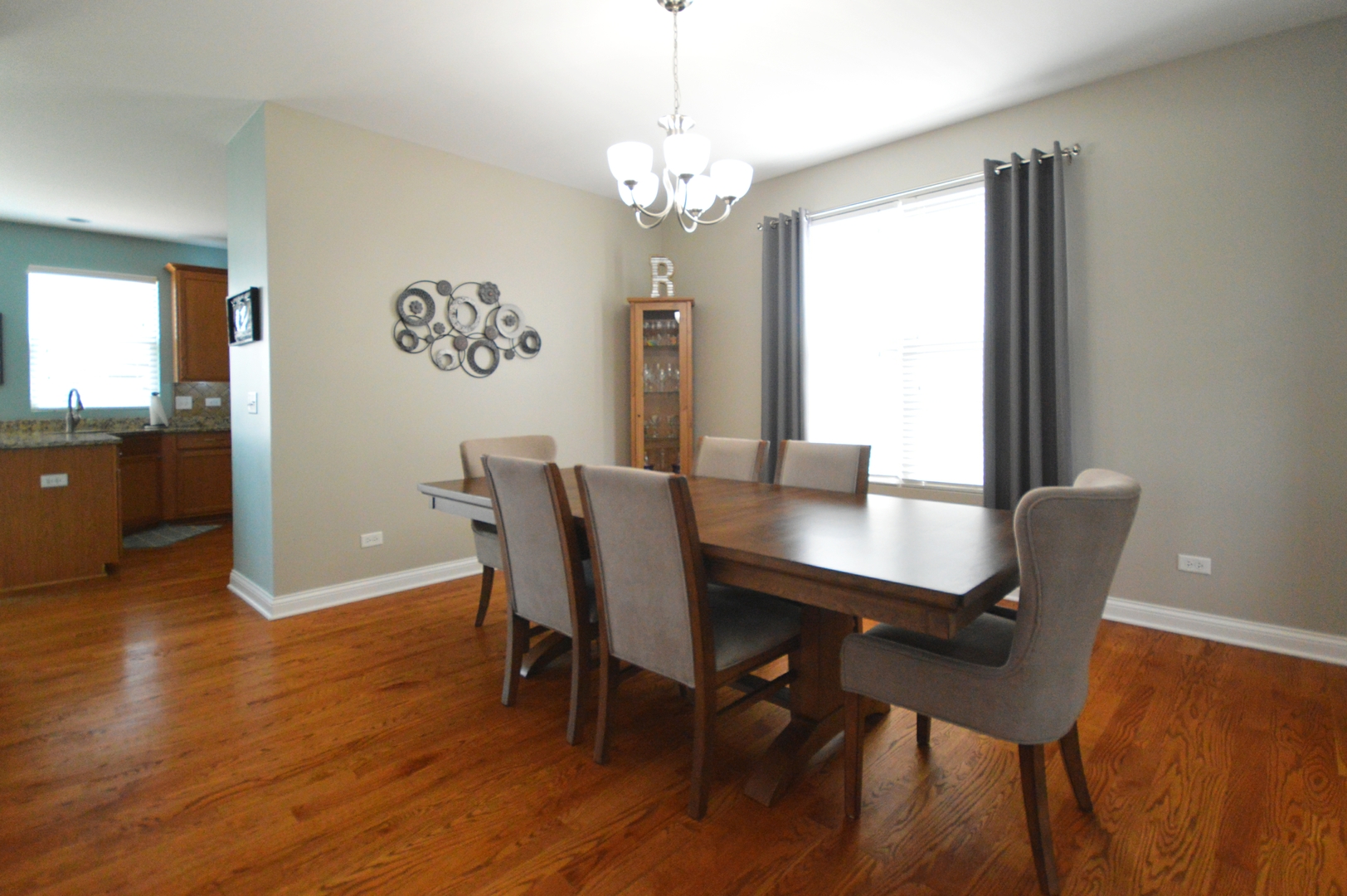 1504 Roth Drive Joliet, IL 60431 - Photo 6 of 27 a view of a dining room with furniture window and wooden floor