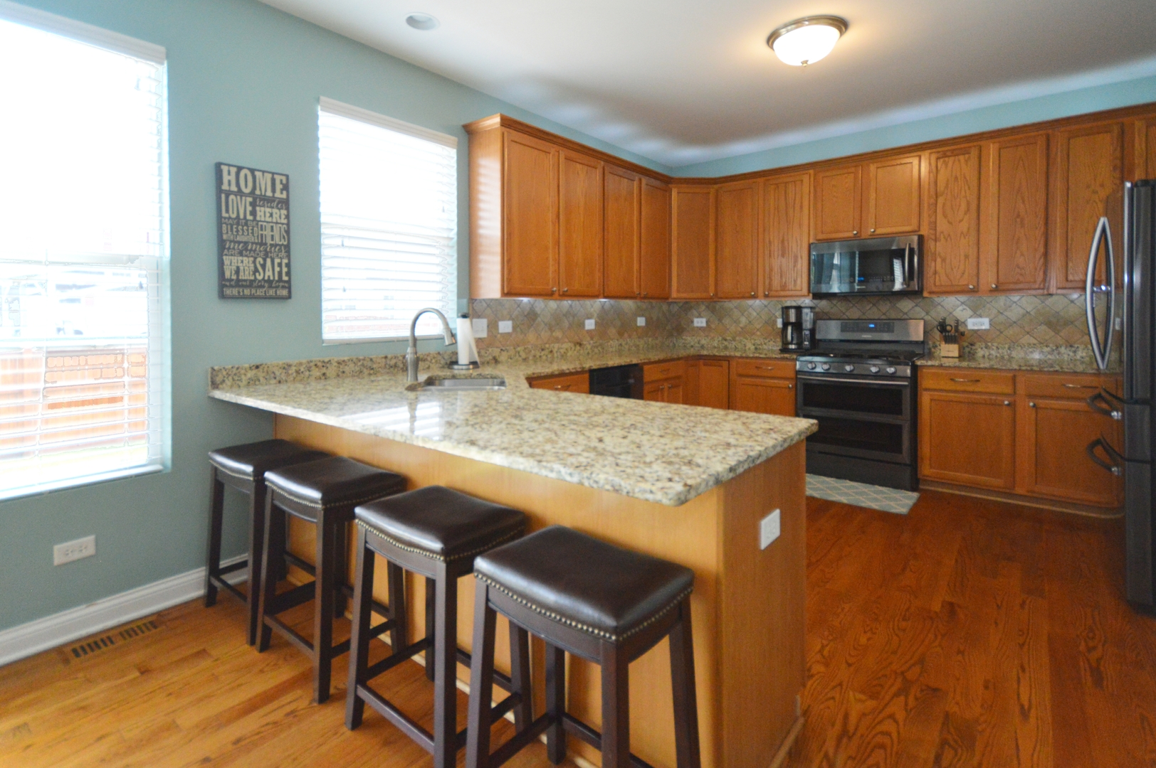 1504 Roth Drive Joliet, IL 60431 - Photo 7 of 27 a kitchen with granite countertop wooden cabinets and stainless steel appliances