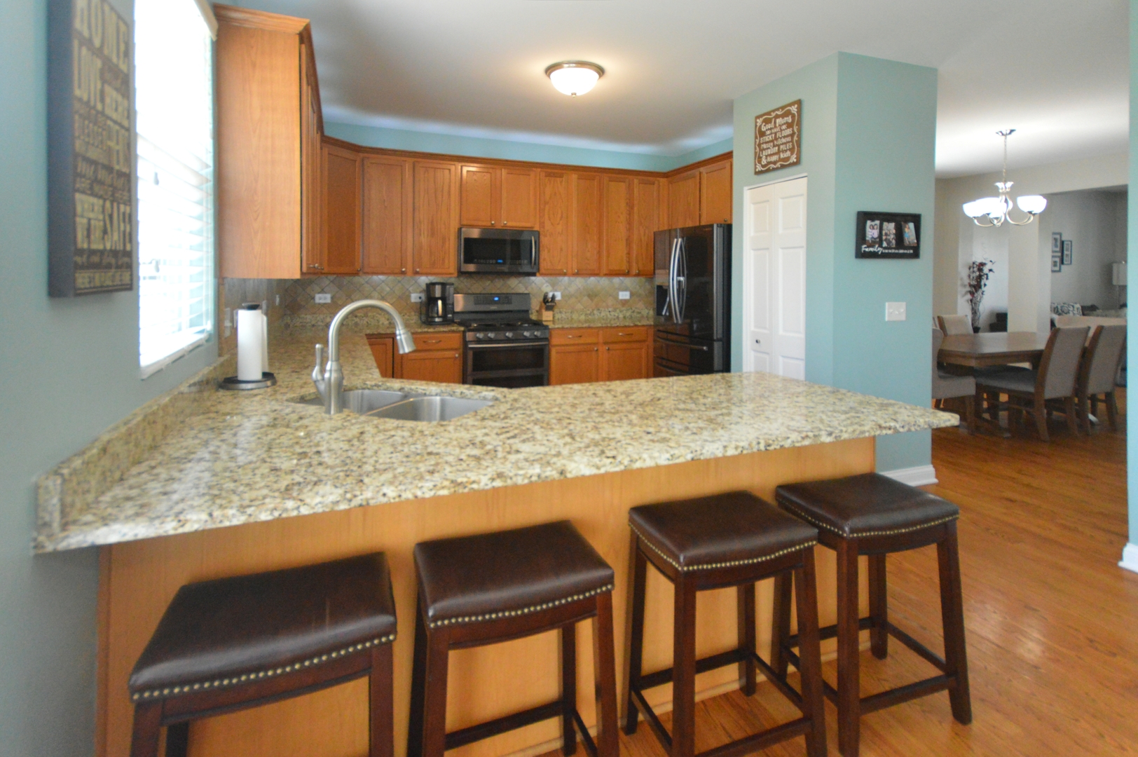 1504 Roth Drive Joliet, IL 60431 - Photo 8 of 27 a kitchen with granite countertop kitchen island cabinets and refrigerator