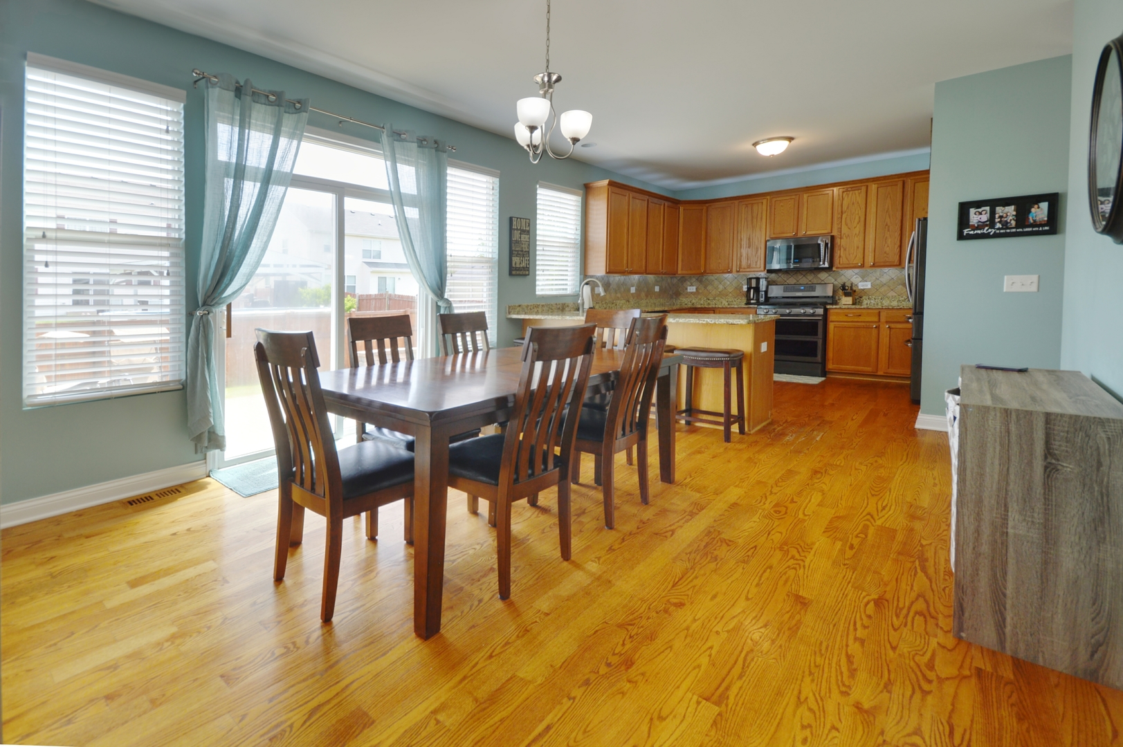 1504 Roth Drive Joliet, IL 60431 - Photo 9 of 27 a view of a dining room with furniture window and wooden floor