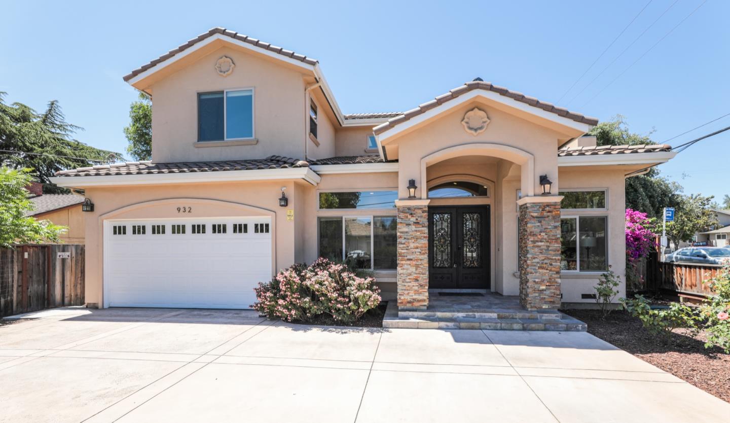 a view of a house with large windows and a yard