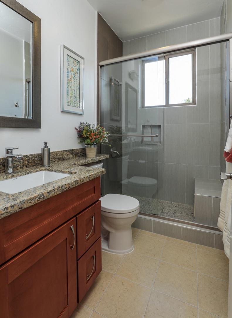 932 Marion Way Sunnyvale, CA 94087 - Photo 18 of 37 a bathroom with a granite countertop sink toilet and shower